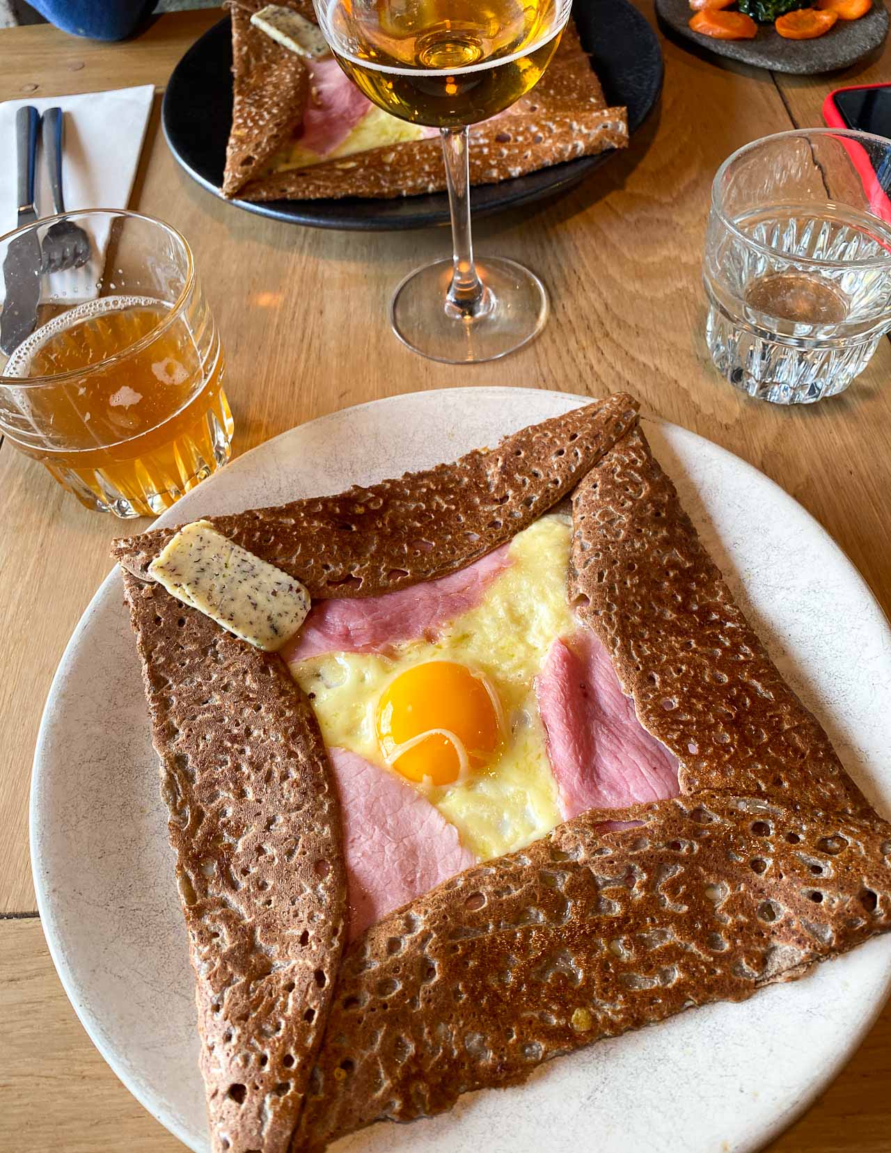Breizh Café signature dishes Galette Complète (Ham, Egg, Cheese)Galette with Smoked Herring and PotatoesCaramel au Beurre Salé CrêpeSelection of Artisanal Ciders